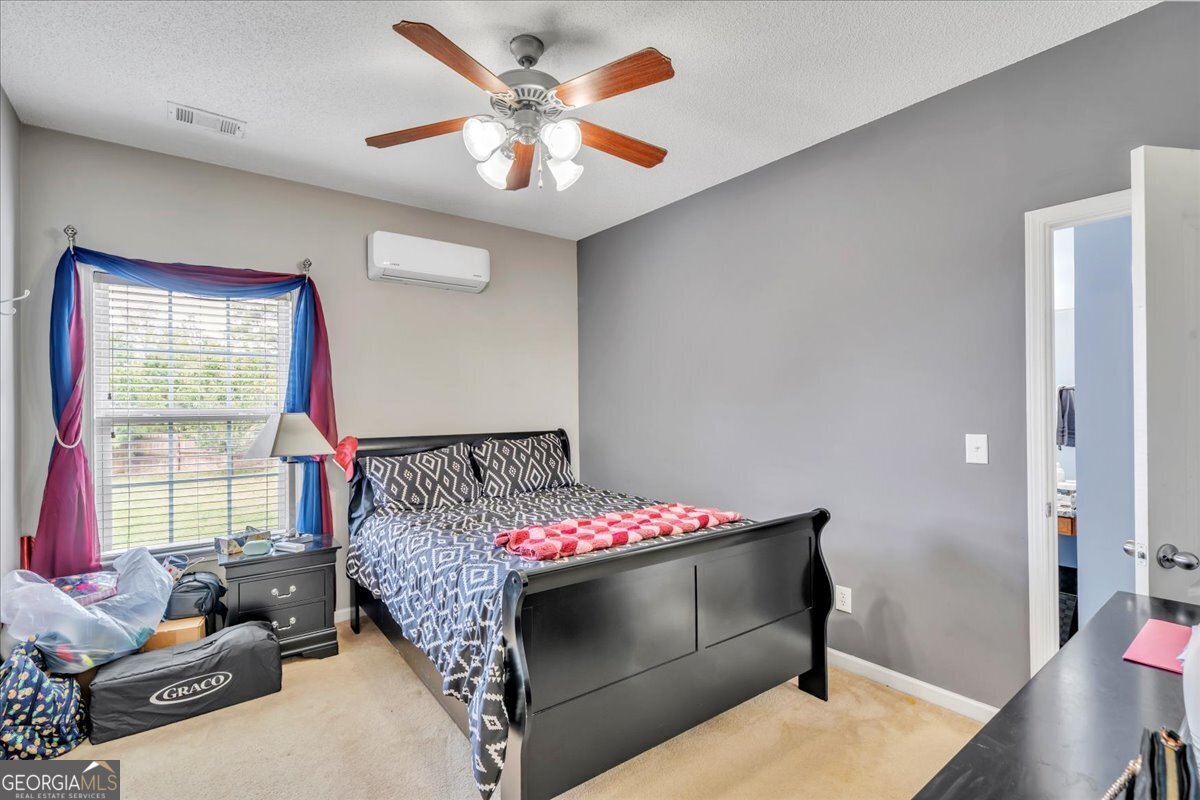 605 Dodds Walk Macon, GA 31220 - Photo 29 of 68 a bedroom with a bed and a chandelier