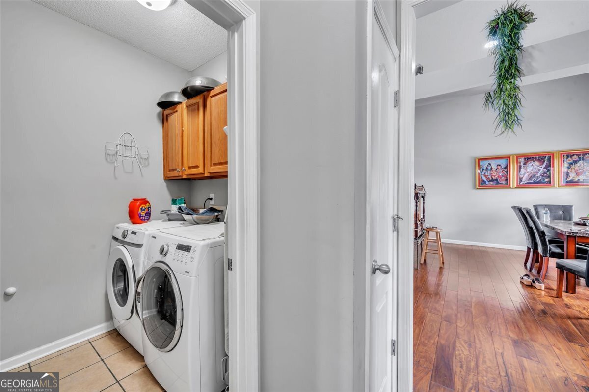 605 Dodds Walk Macon, GA 31220 - Photo 31 of 68 a utility room with dryer washer and a view of living room