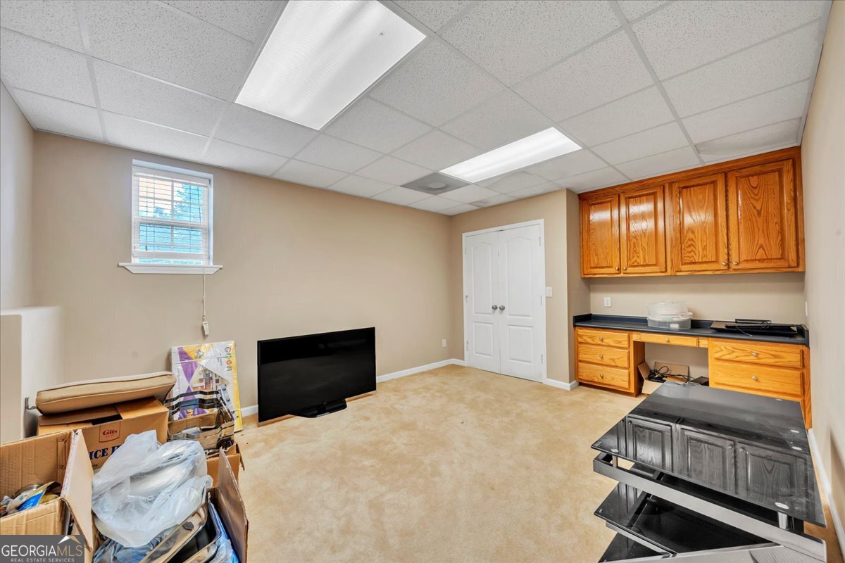 605 Dodds Walk Macon, GA 31220 - Photo 32 of 68 a bedroom with a bed and wooden floor
