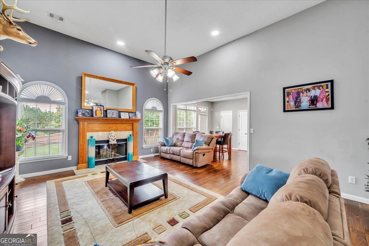 605 Dodds Walk Macon, GA 31220 - Photo 5 of 68 a living room with furniture a fireplace and a flat screen tv