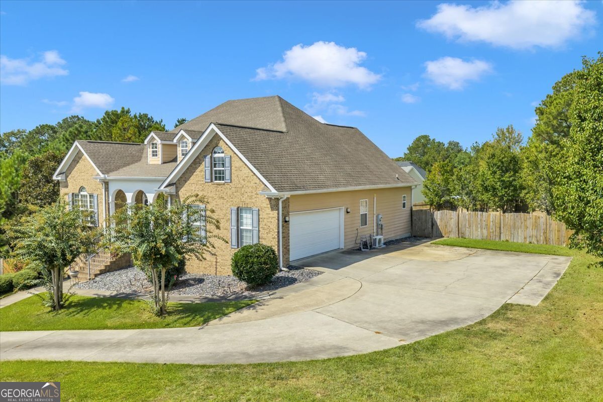 605 Dodds Walk Macon, GA 31220 - Photo 53 of 68 a view of a house with a yard and potted plants