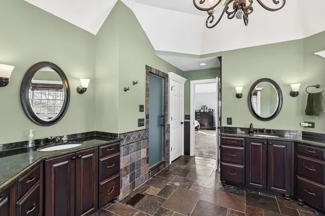 a bathroom with a granite countertop sink a mirror and a mirror