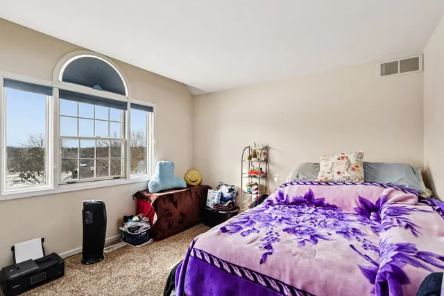 a bed room with a bed and a window