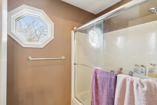 a bathroom with a bathtub and a shower