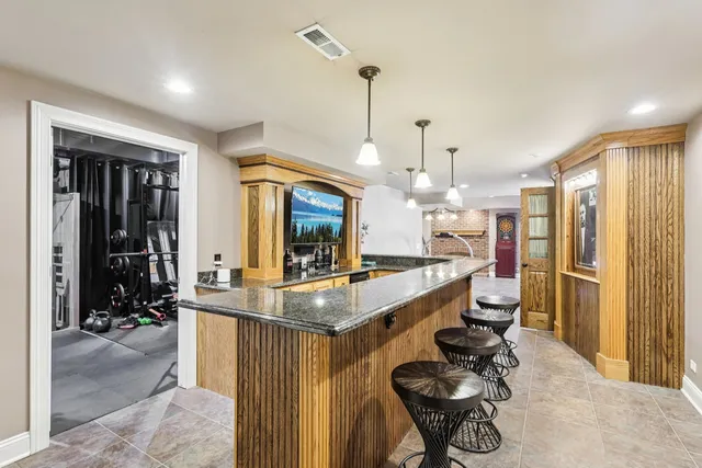 a kitchen with sink refrigerator and dining table