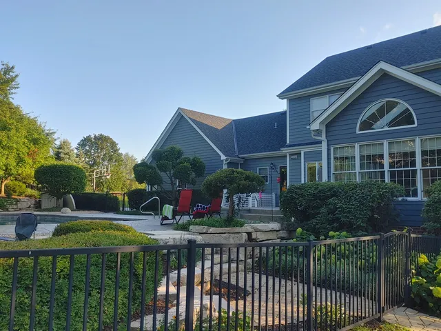 a front view of house and yard with green space