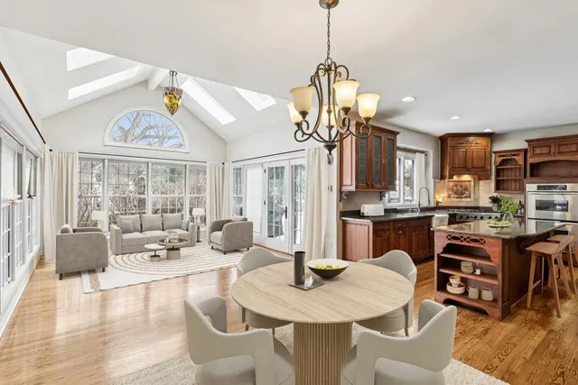 a view of a dining room with furniture large windows and wooden floor