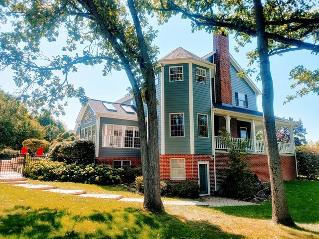 a front view of a house with yard and green space