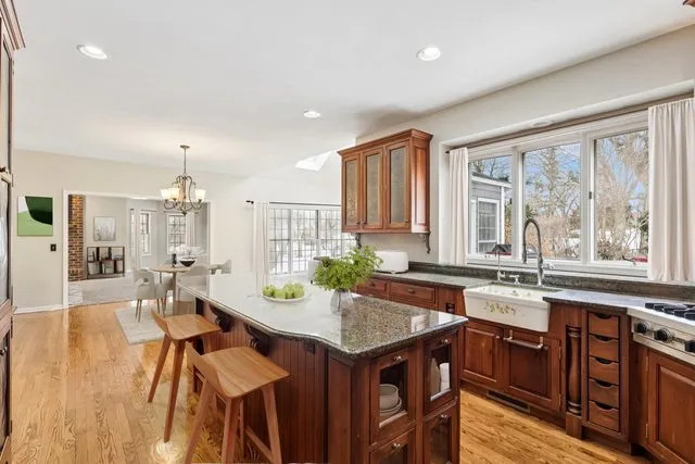 a view of a kitchen with granite countertop lots of counter top space and dining table