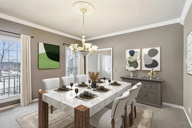 a view of a dining room with furniture wooden floor and chandelier