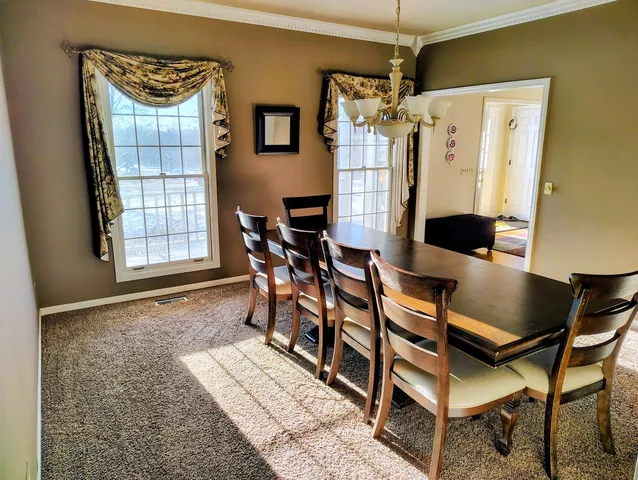 a dining room with furniture and window