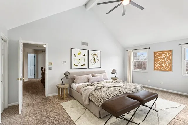 a bedroom with a bed and glass windows