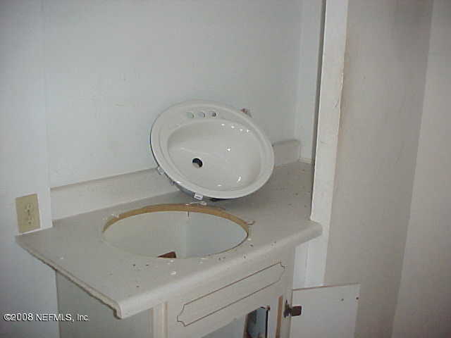 396 Beecher Springs Road Crescent City, FL 32112 - Photo 12 of 17 a bathroom with a sink and a mirror