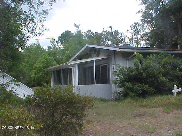 396 Beecher Springs Road Crescent City, FL 32112 - Photo 8 of 17 a house with trees in the background