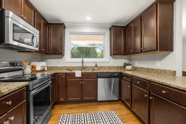 a kitchen with a sink stove top oven and cabinets