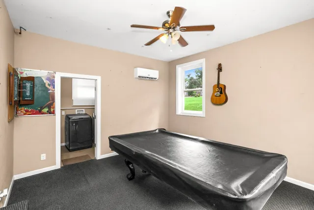 a living room with pool table