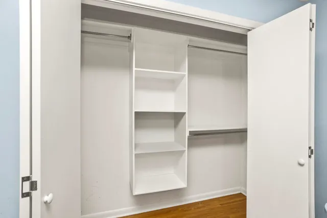 a view of walk in closet with empty racks