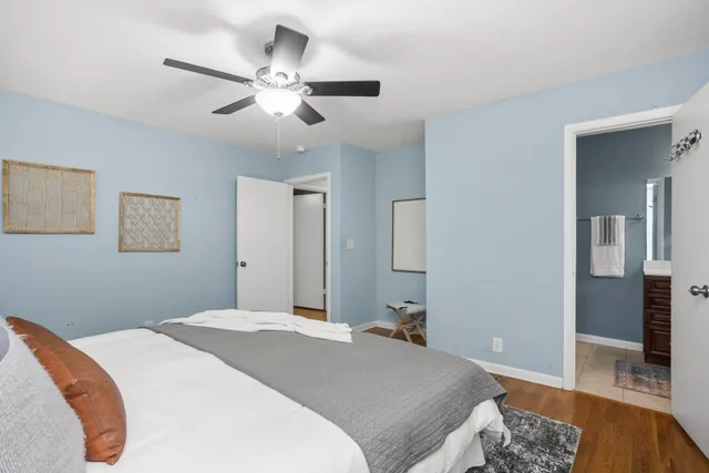 a bedroom with a large bed and a chandelier