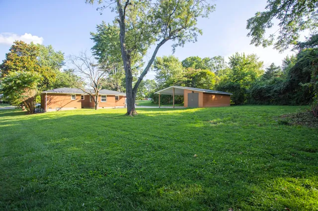 a house view with swimming pool in front of it