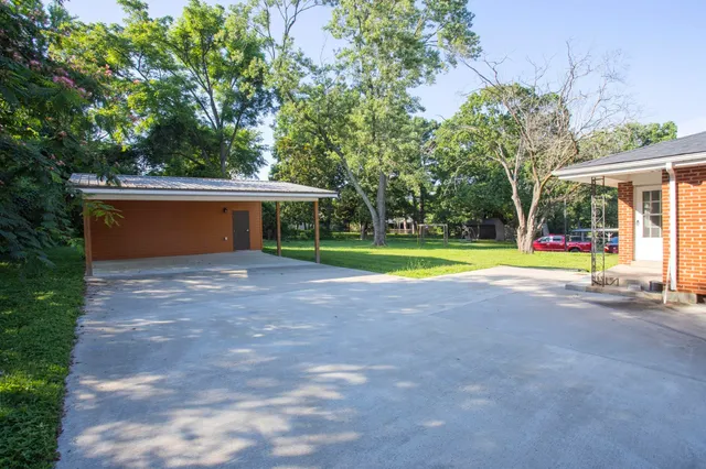 a view of backyard with swimming pool and outdoor seating