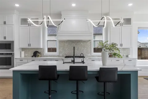 a kitchen with a sink cabinets and window