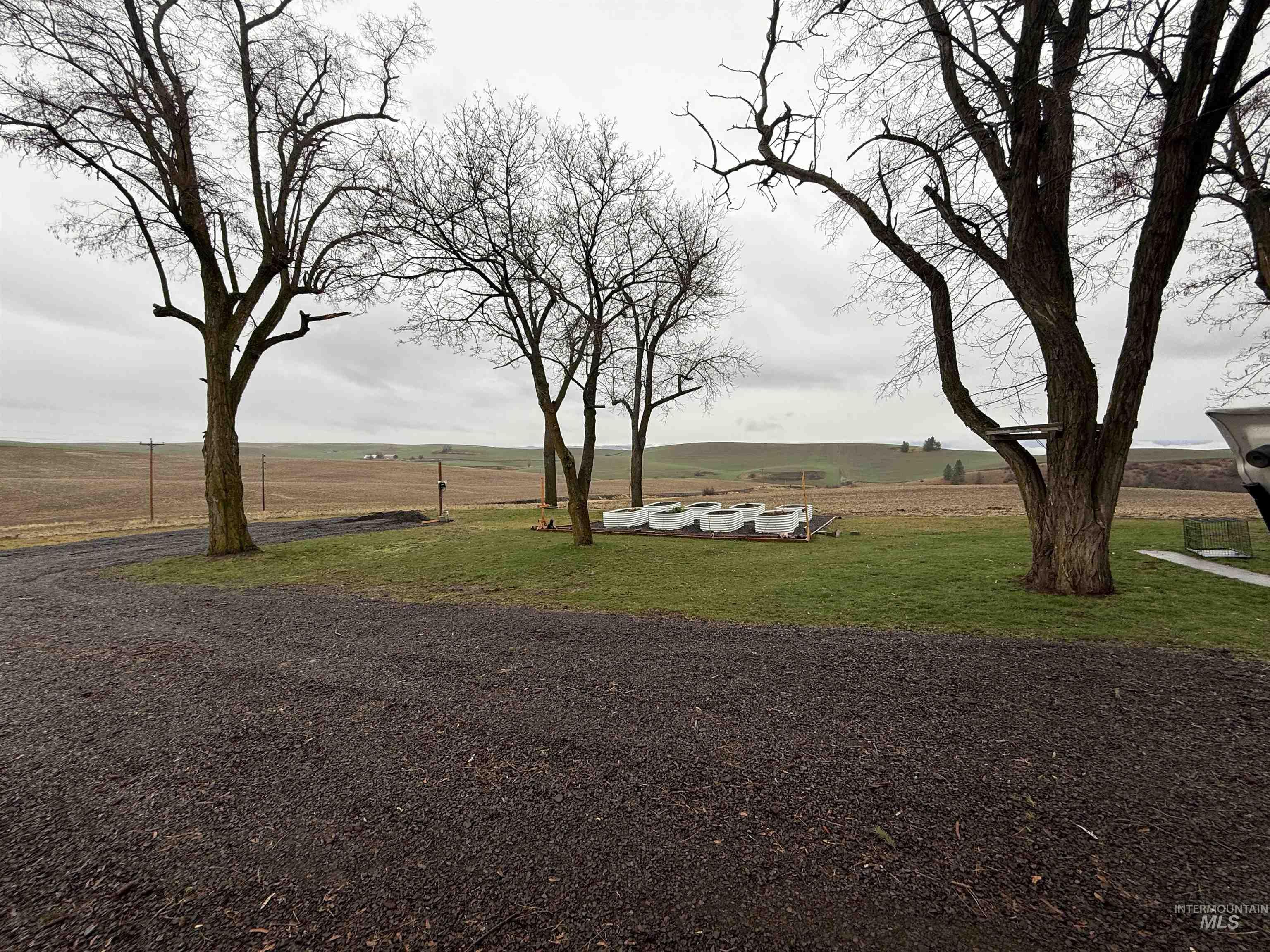 16078 Hoffman Road Kendrick, ID 83537 - Photo 23 of 29 Dining room with light wood-style floors, arched walkways, ceiling fan, and french doors