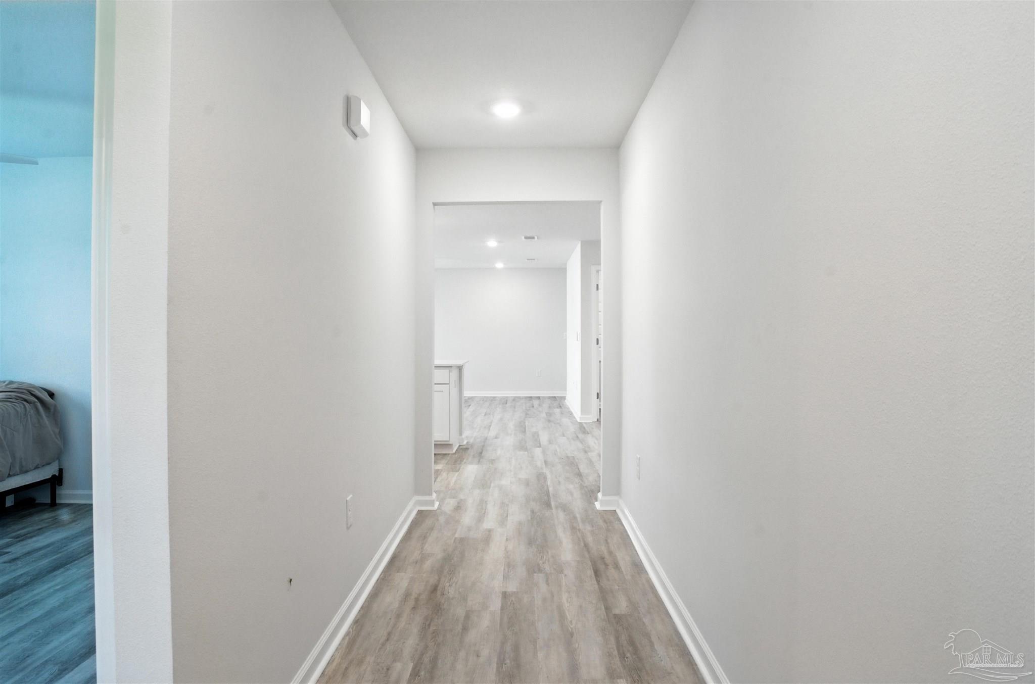 4710 Carl Booker Road Milton, FL 32583 - Photo 12 of 54 a view of a hallway with wooden floor and closet