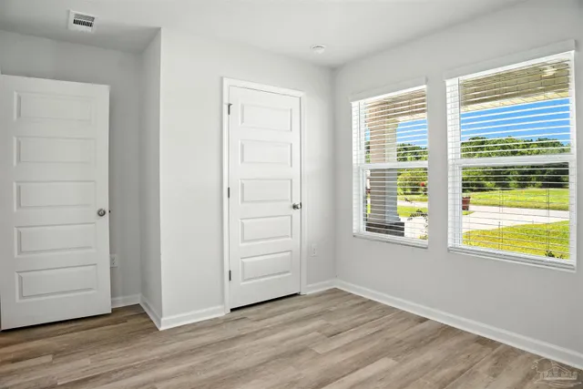 a bedroom with a bed and a chair