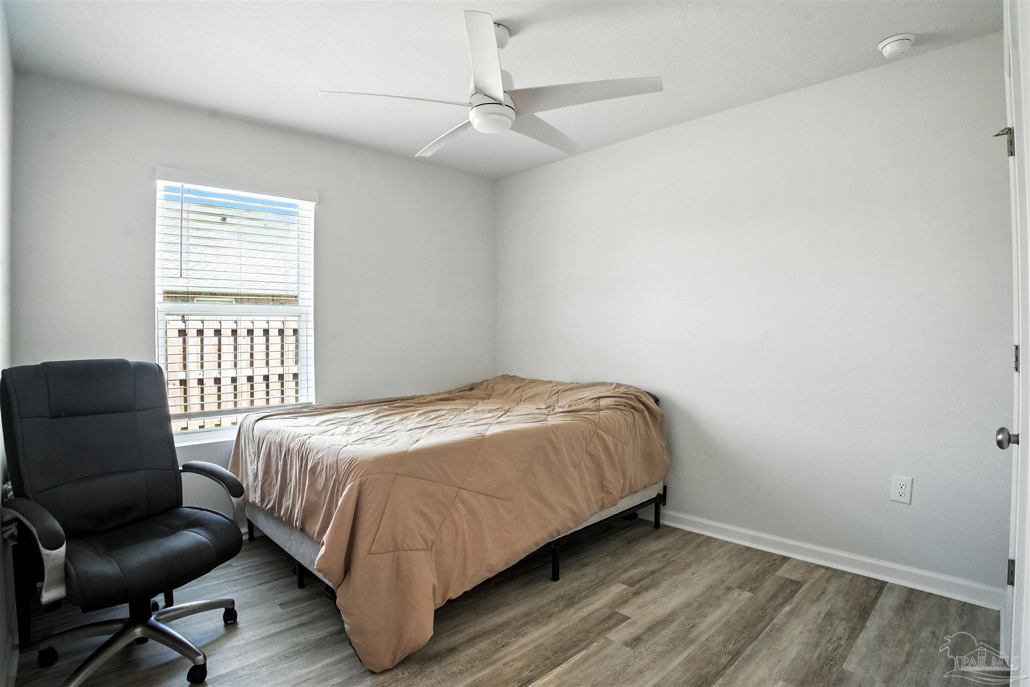4710 Carl Booker Road Milton, FL 32583 - Photo 16 of 54 a bedroom with a bed and a chair