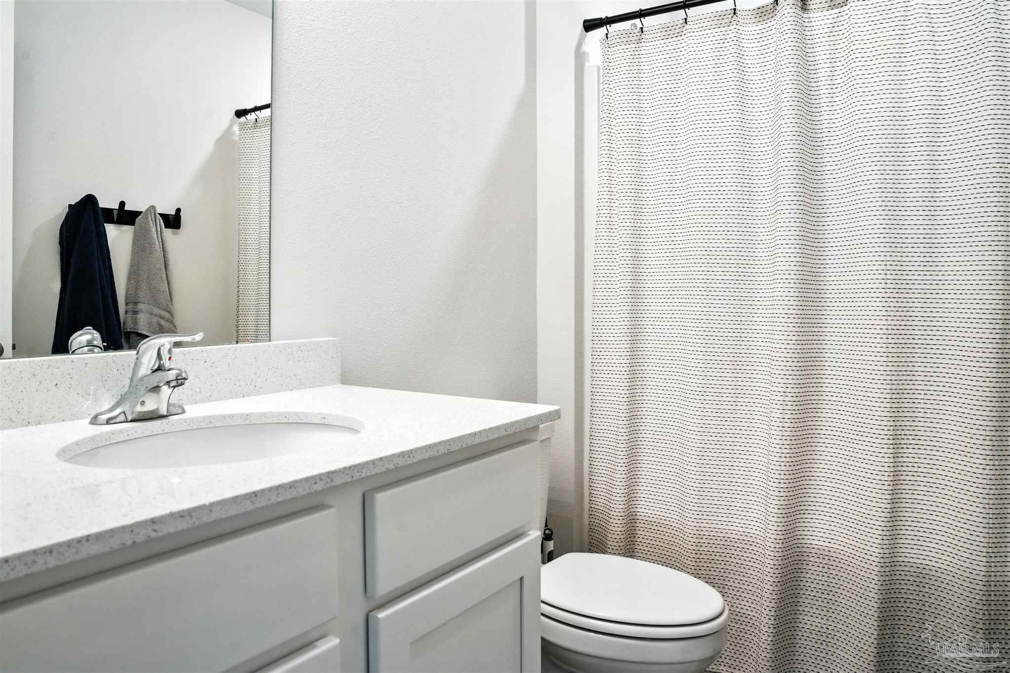 4710 Carl Booker Road Milton, FL 32583 - Photo 19 of 54 a bathroom with a sink a toilet and mirror