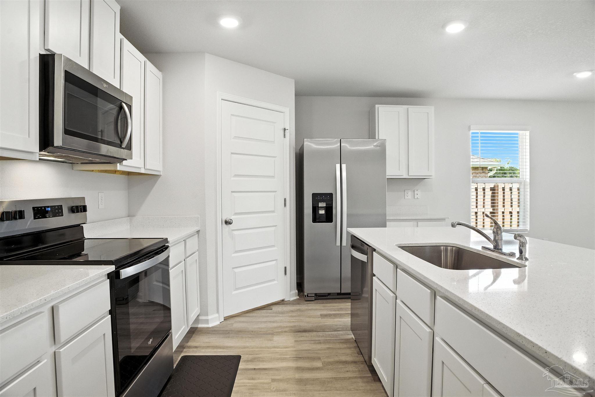 4710 Carl Booker Road Milton, FL 32583 - Photo 20 of 54 a kitchen that has a sink and a stove top oven