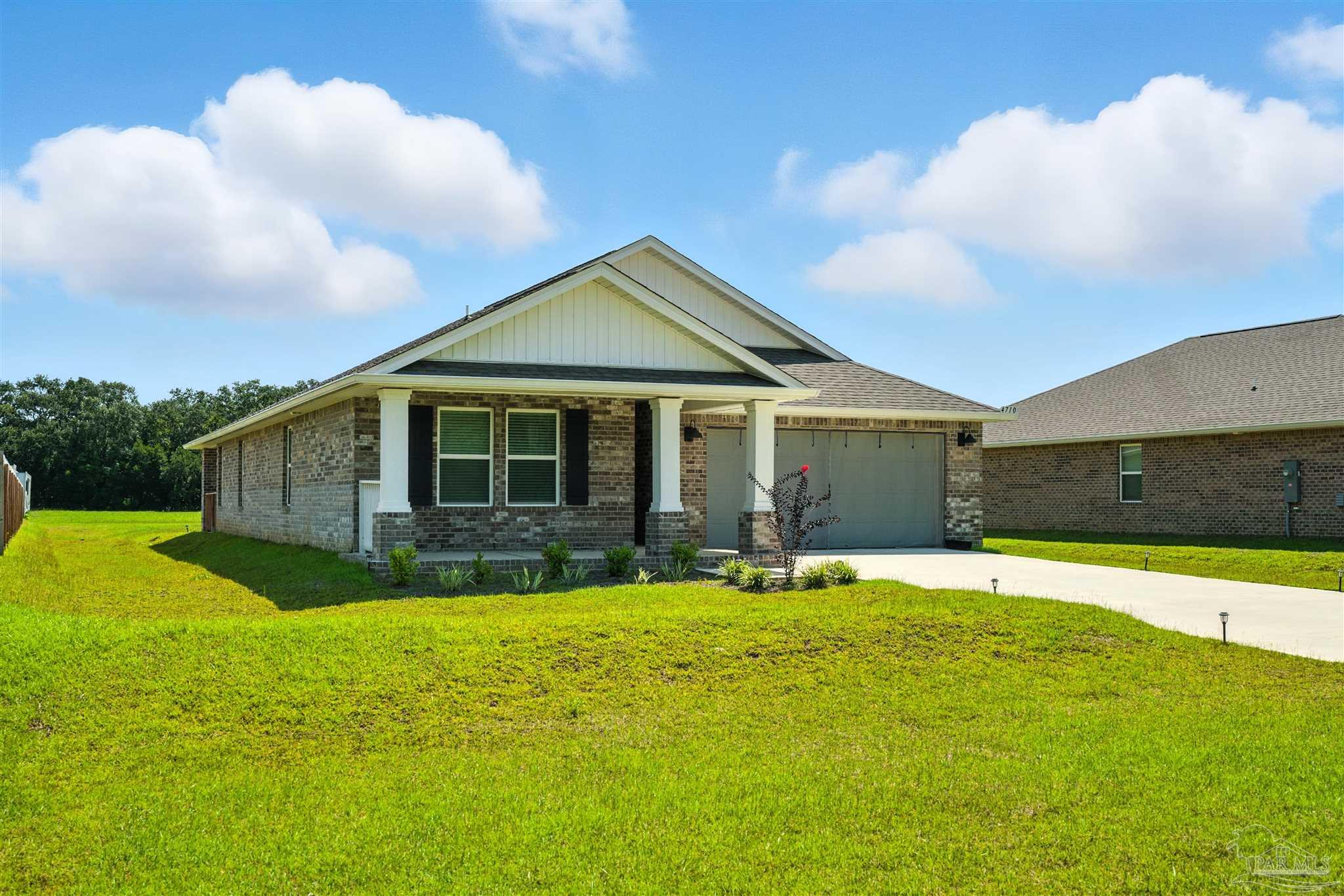 4710 Carl Booker Road Milton, FL 32583 - Photo 2 of 54 a view of a house with a yard and pathway