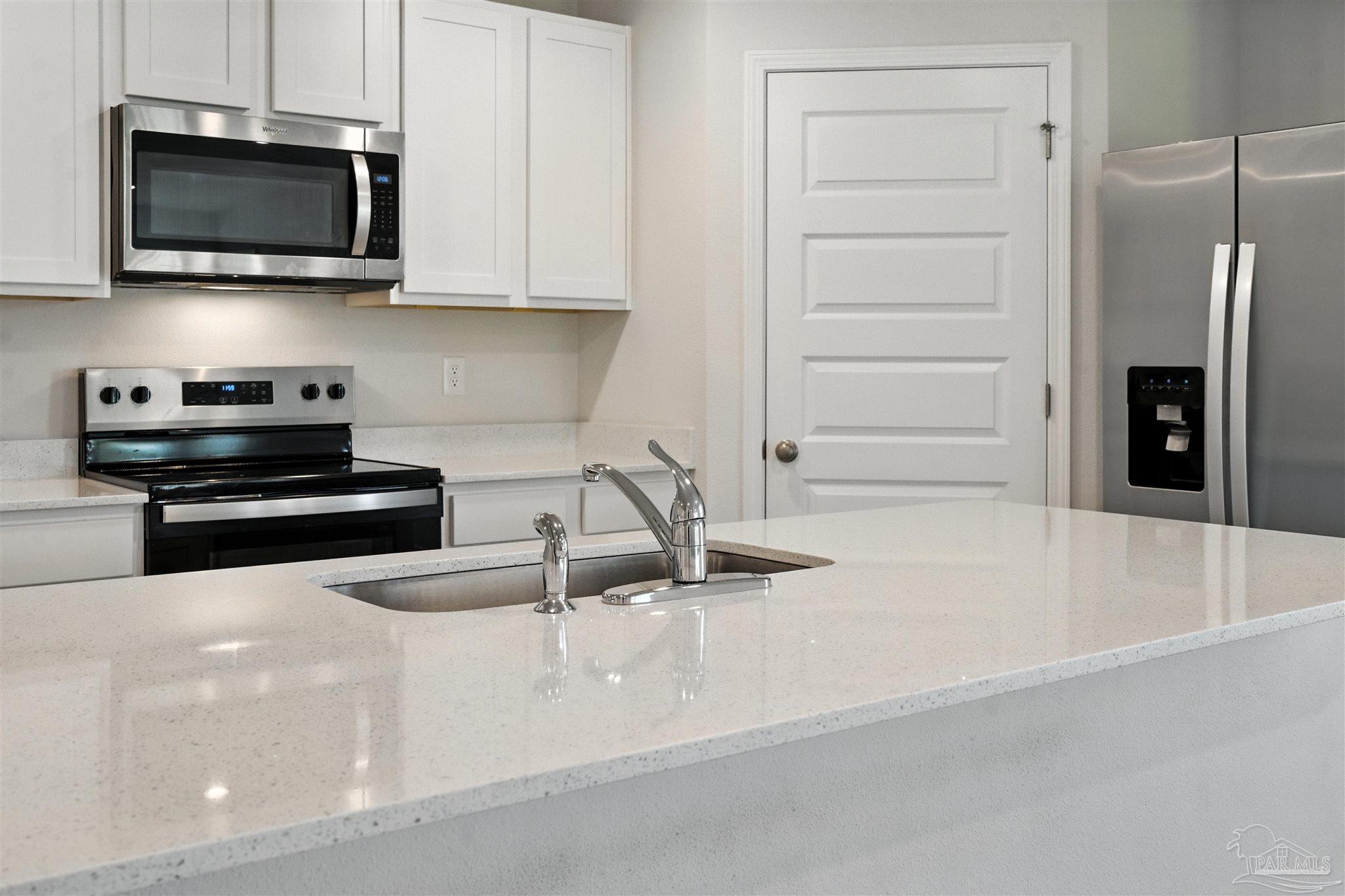 4710 Carl Booker Road Milton, FL 32583 - Photo 21 of 54 a kitchen with stainless steel appliances granite countertop a sink and a microwave