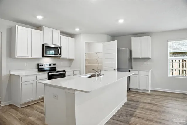 an empty room with wooden floor and ceiling fan