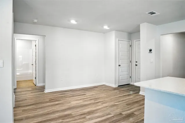 a kitchen with granite countertop a refrigerator and a stove top oven