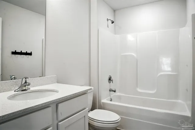 an empty room with wooden floor and ceiling fan