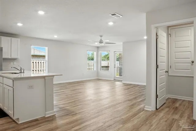 an empty room with window and wooden floor