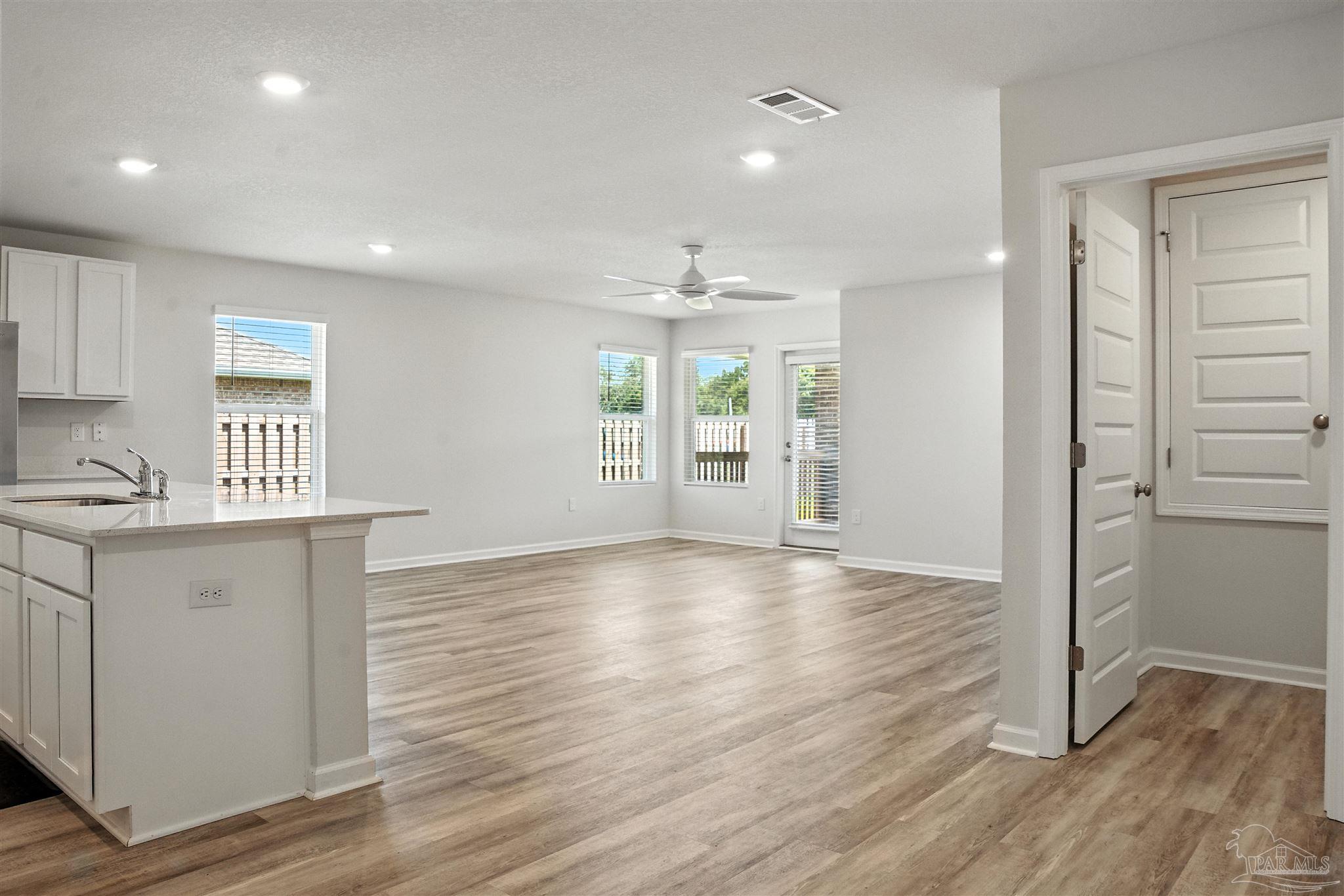 4710 Carl Booker Road Milton, FL 32583 - Photo 35 of 54 a view of an empty room with wooden floor and a window