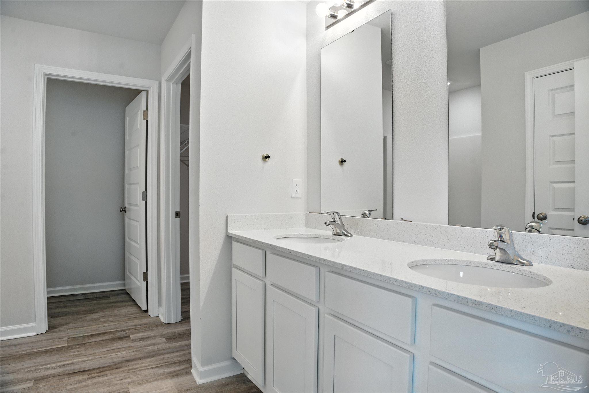 4710 Carl Booker Road Milton, FL 32583 - Photo 40 of 54 a bathroom with a double vanity sink and mirror