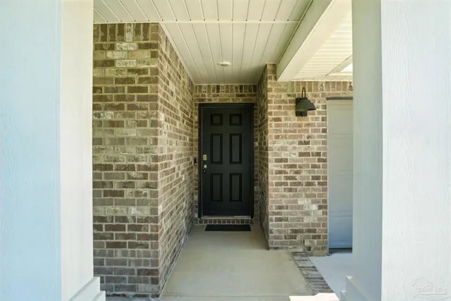a view of entryway with brick walls