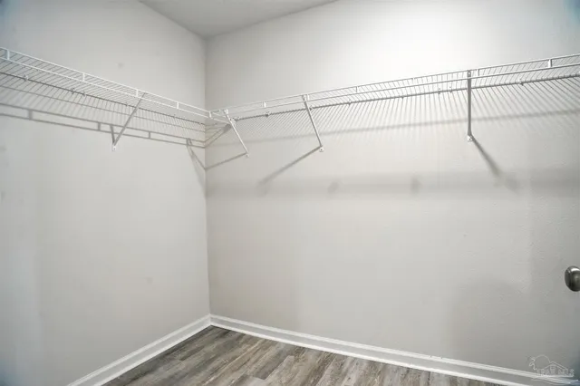 a white toilet sitting next to a white wall