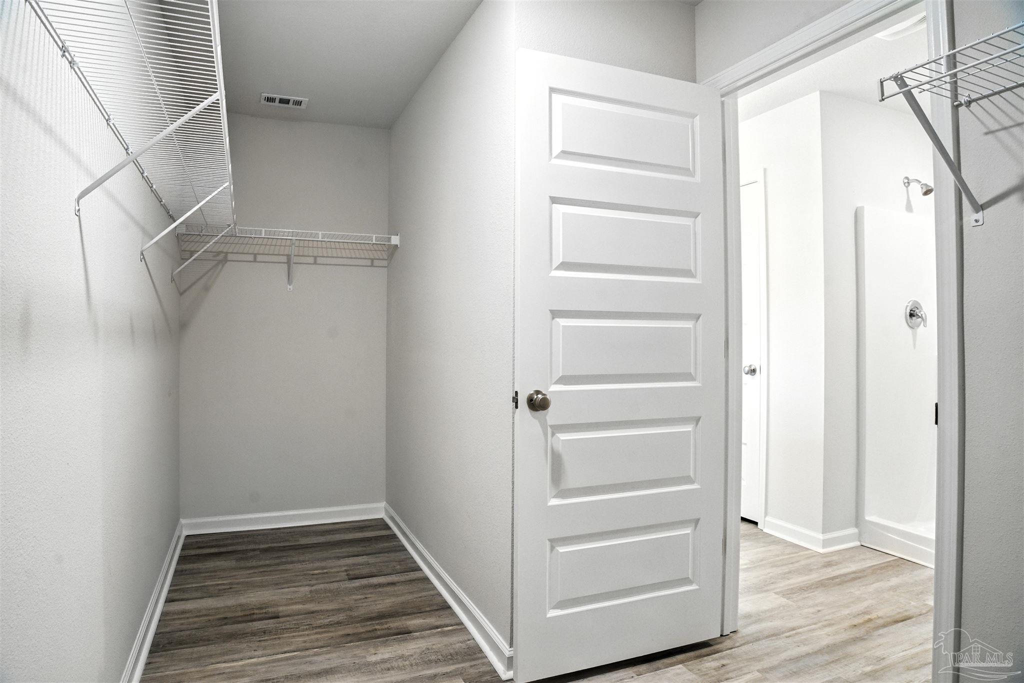 4710 Carl Booker Road Milton, FL 32583 - Photo 42 of 54 a view of walk in closet with empty racks