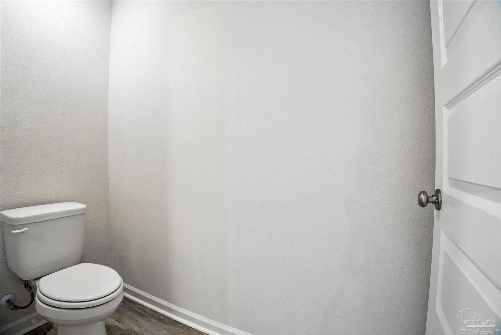 4710 Carl Booker Road Milton, FL 32583 - Photo 43 of 54 a white toilet sitting next to a white wall