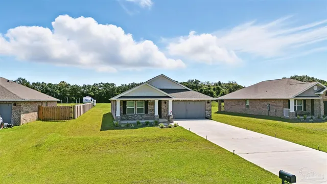 a view of an swimming pool with lawn chairs under an umbrella