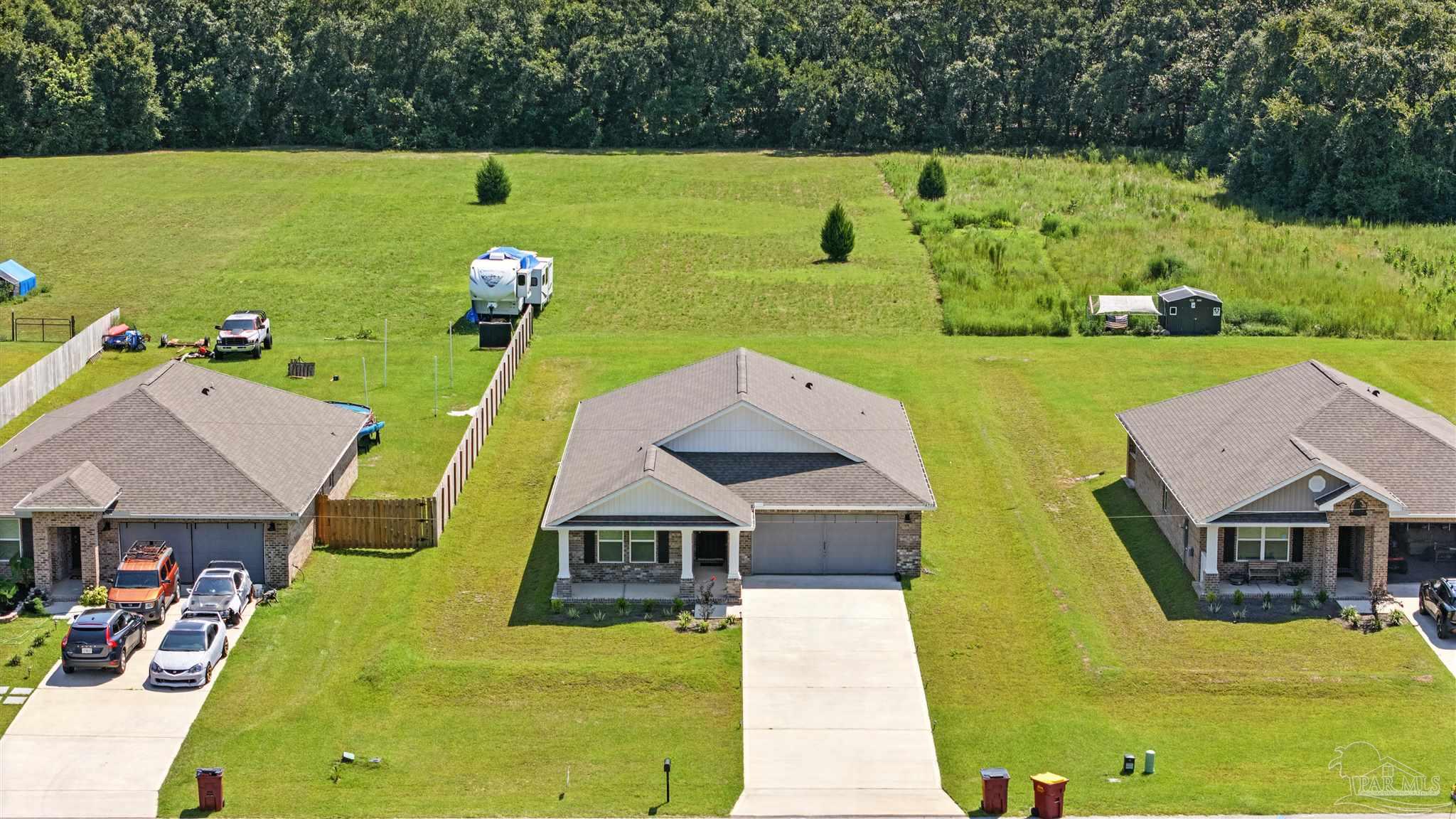 4710 Carl Booker Road Milton, FL 32583 - Photo 48 of 54 an aerial view of a house with a garden