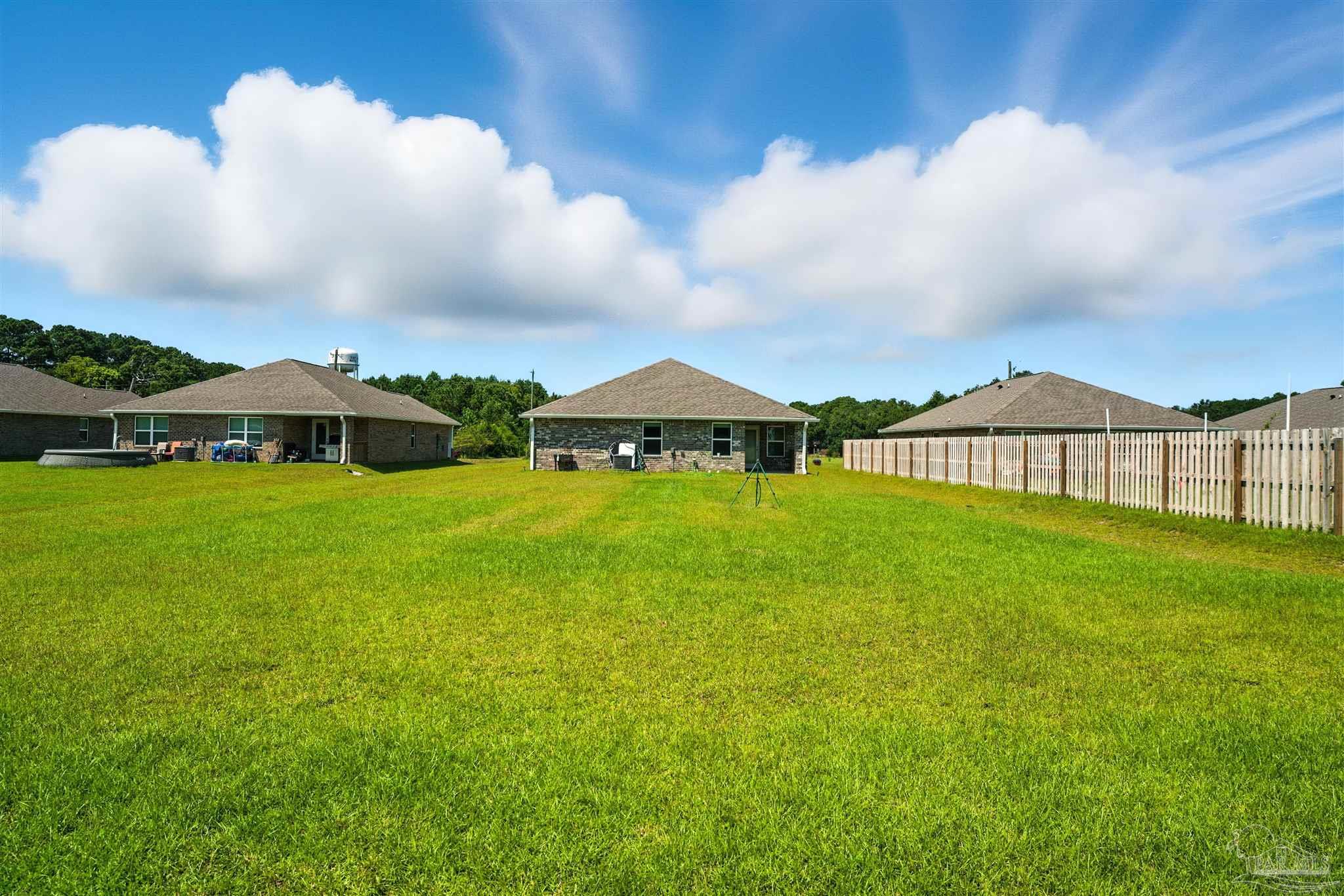 4710 Carl Booker Road Milton, FL 32583 - Photo 8 of 54 a view of an house with backyard and garden