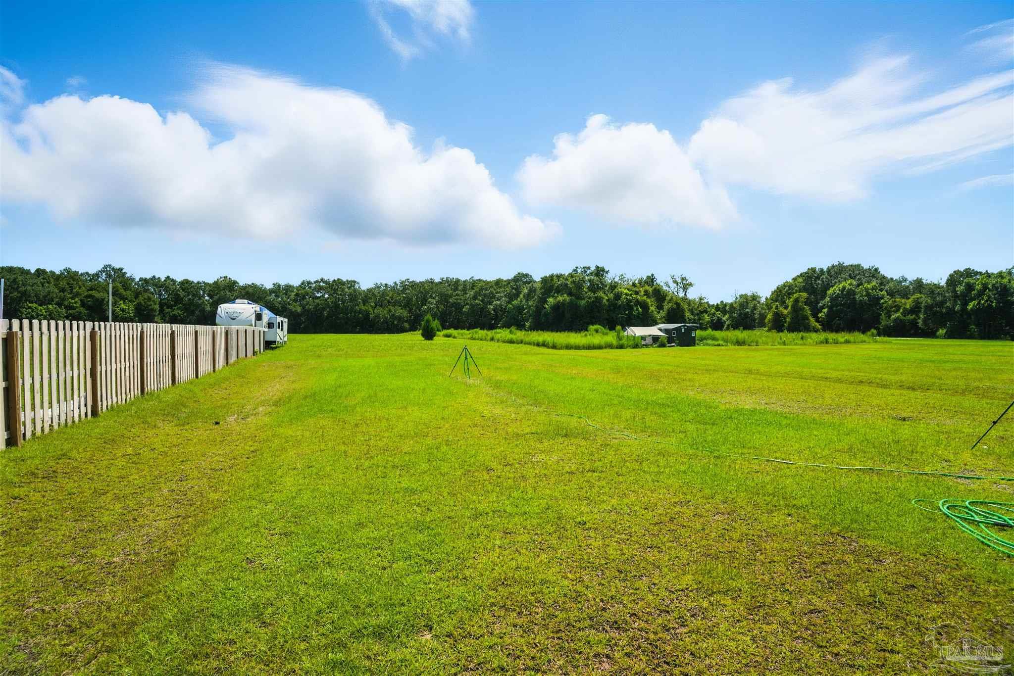 4710 Carl Booker Road Milton, FL 32583 - Photo 10 of 54 a view of yard with swimming pool and green space