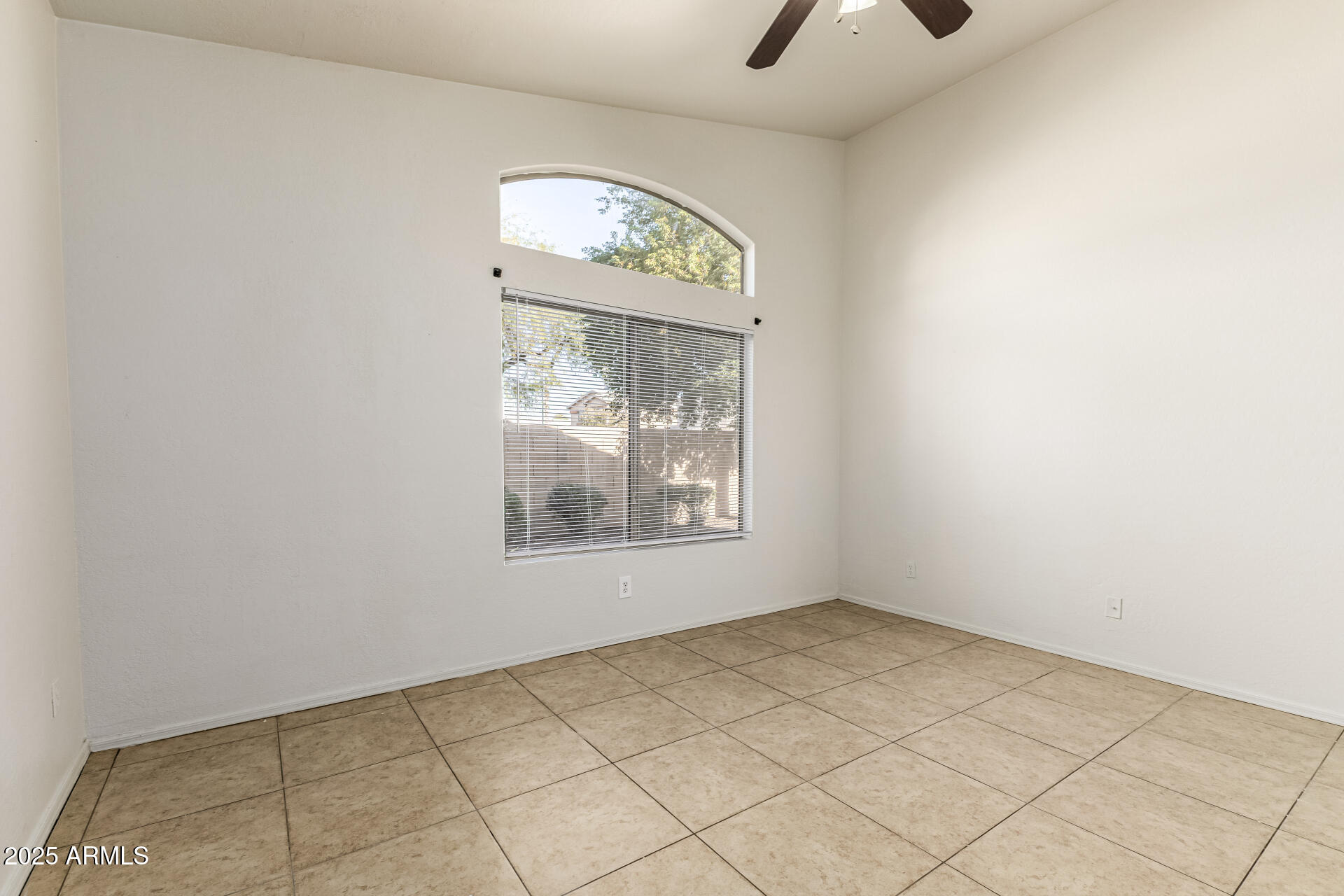 10628 West Coronado Road Avondale, AZ 85392 - Photo 13 of 29 an empty room with windows and fan