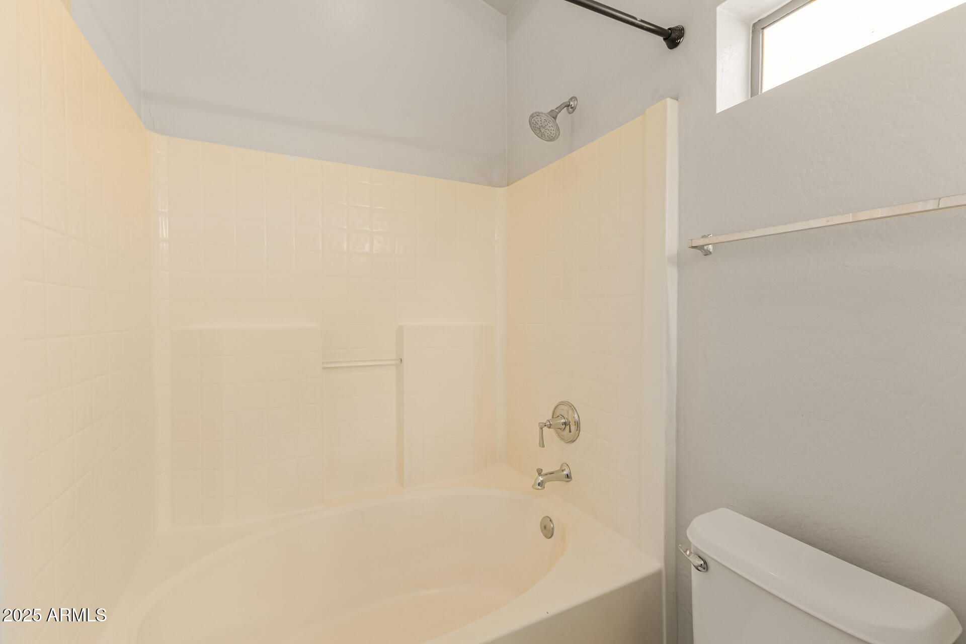 10628 West Coronado Road Avondale, AZ 85392 - Photo 15 of 29 a bathroom with a bathtub and a toilet