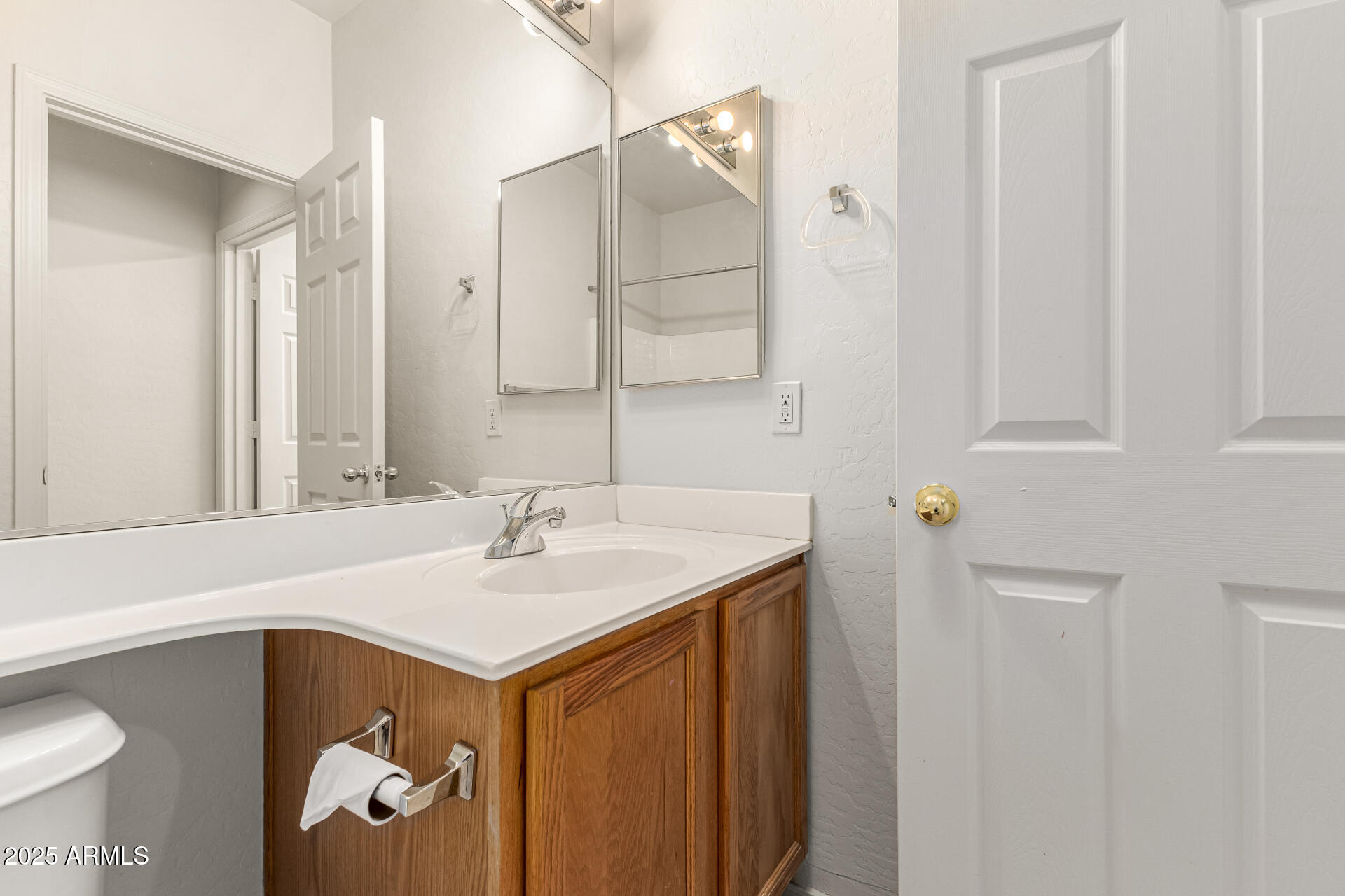 10628 West Coronado Road Avondale, AZ 85392 - Photo 23 of 29 a bathroom with a sink and a mirror